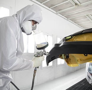 Collision Center Technician Painting a Vehicle | Advantage Toyota Valley Stream in Valley Stream NY